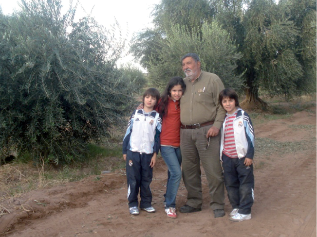 Julio Nolly in the estate olive groves with his grandchildren